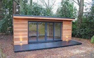 Extension latérale de maison en bois naturel, toit plat